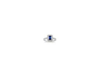 Minimal, modern, and perfectly feminine, this blue sapphire ring exudes a quiet, confident sense of style. The shimmering 6x4mm emerald-cut center blue sapphire is prong-set in 18k white gold, haloed by .33twt round brilliant-cut diamonds that also adorn 