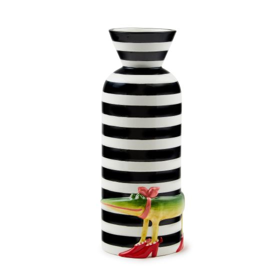 Patience Brewster's Gloria Alligator is a tribute to humor, to kicking up your heels, and to grinning, no matter what. Present your prettiest posies in the ceramic Patience Brewster Gloria Alligator Vase, featuring hand-painted Gloria on a backdrop of bol