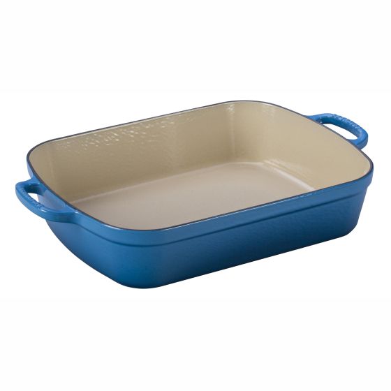 Roast meats poultry vegetables and more with this cast iron roaster. Enameled cast iron delivers superior heat distribution and retention. Ready to use requires no seasoning. Easy-to-clean and durable enamel resists dulling staining chipping and cracking.