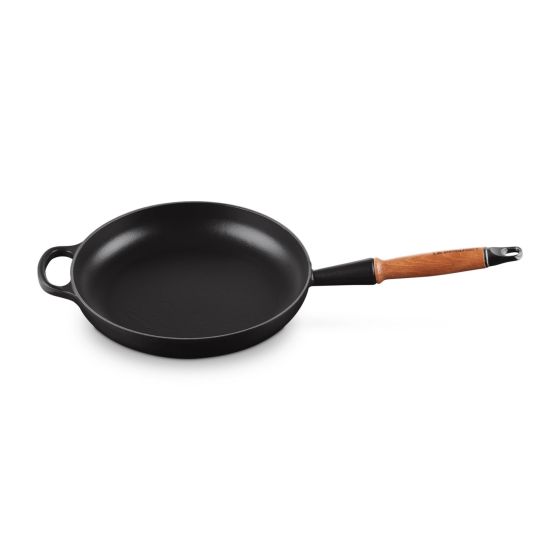 Enameled cast iron delivers superior heat distribution and retention. Durable enamel resists dulling staining chipping and cracking. Black satin interiors develop a patina over time to enhance performance. Maple-stained beechwood handle stays cool to the 