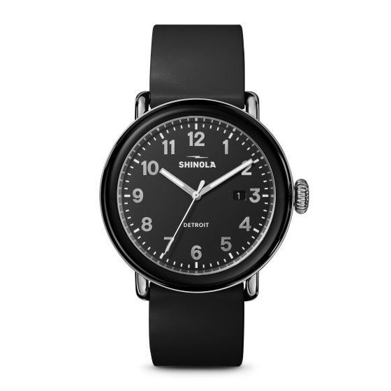 Detrola is designed with a classic silhouette and bold attitude. Black rubber strap with traditional buckle closure. Black dial with Arabic numerals and three hands. Day of the month calendar by the 3 position. Black stainless steel and TR 90 resin bezel 